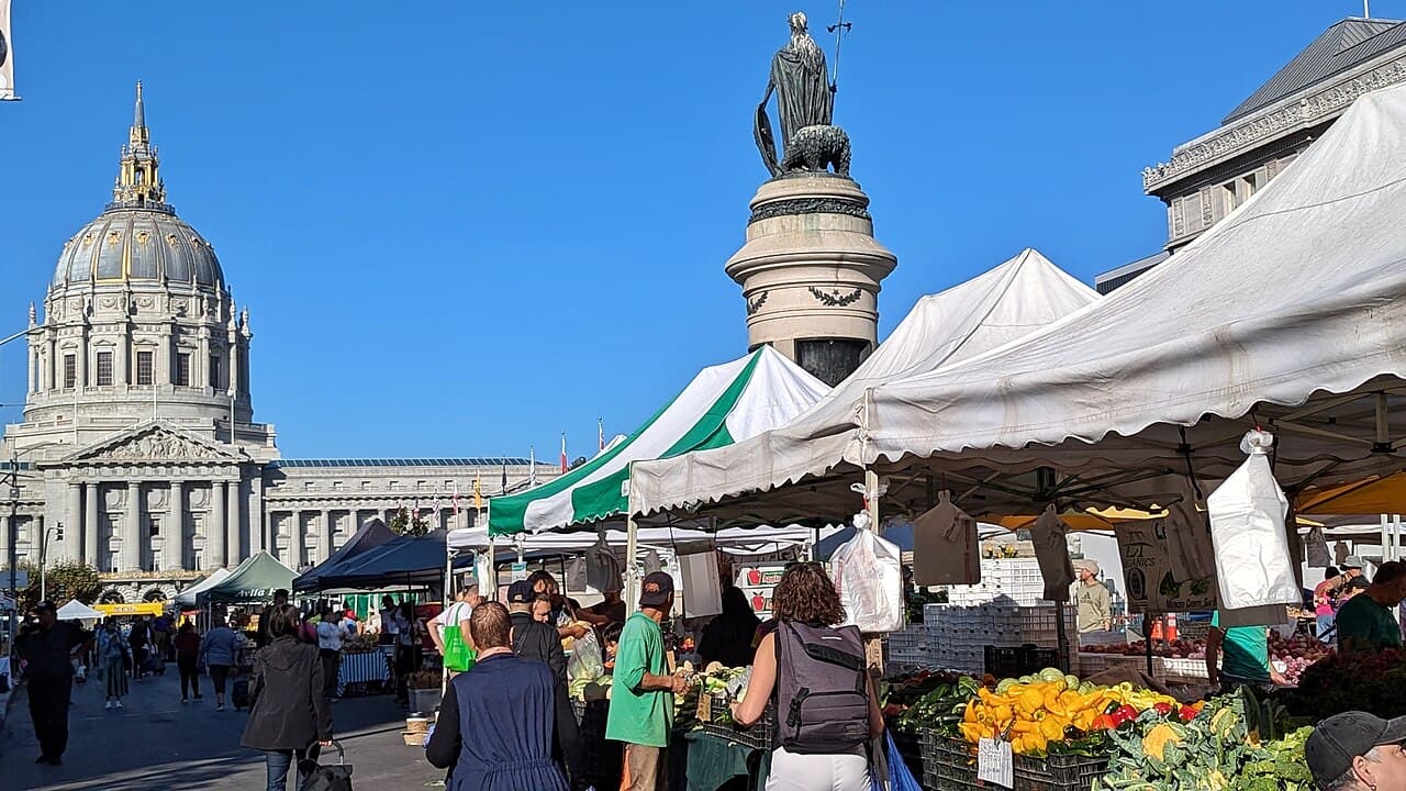 Produce and flower stalls at Heart of the City Farmers Market near City Hall
