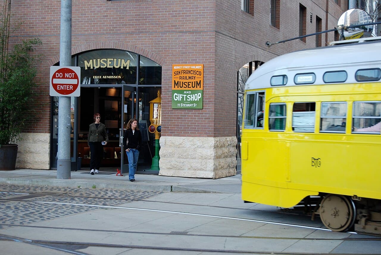 The San Francisco Railway Museum entrance beside a passing yellow streetcar in 2007